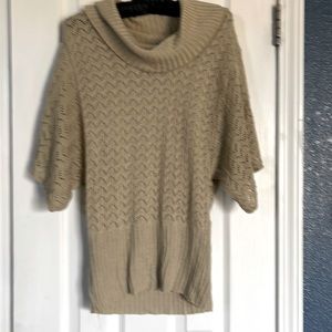 Gold colored lace tunic with wide, floppy, short sleeves.